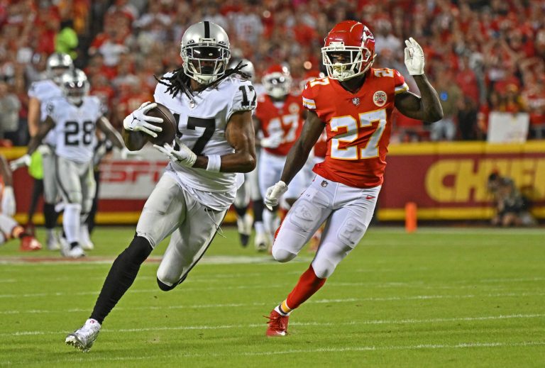 Las Vegas Raiders wide receiver Davante Adams (17) runs for a touchdown against Kansas City Chiefs cornerback Rashad Fenton (27) during an NFL football game Monday, Oct. 10, 2022, in Kansas City, Missouri. Adams is being charged with misdemeanor assault following a post-game shove he did on a cameraman as he was leaving the stadium. (AP Photo/Peter Aiken)