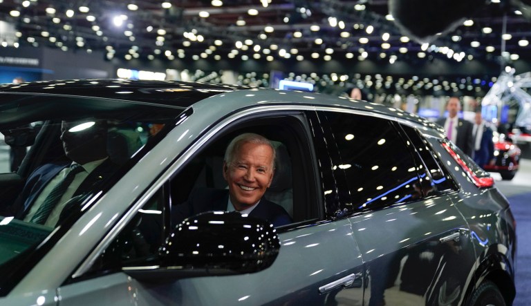President Joe Biden drives a Cadillac Lyriq through the showroom during a tour at the Detroit Auto Show, Sept. 14, 2022, in Detroit.