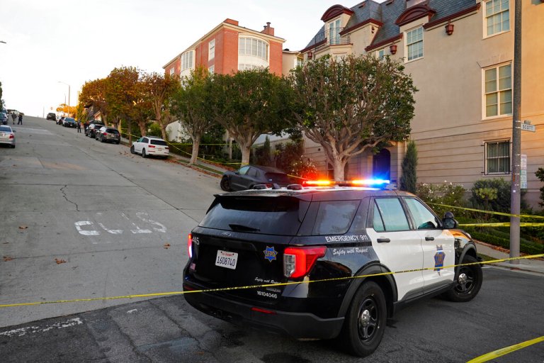 A police car blocks the street below the home of Paul Pelosi, the husband of House Speaker Nancy Pelosi, in San Francisco, Friday, Oct. 28, 2022. Paul Pelosi, was attacked and severely beaten by an assailant with a hammer who broke into their San Francisco home early Friday, according to people familiar with the investigation. 
