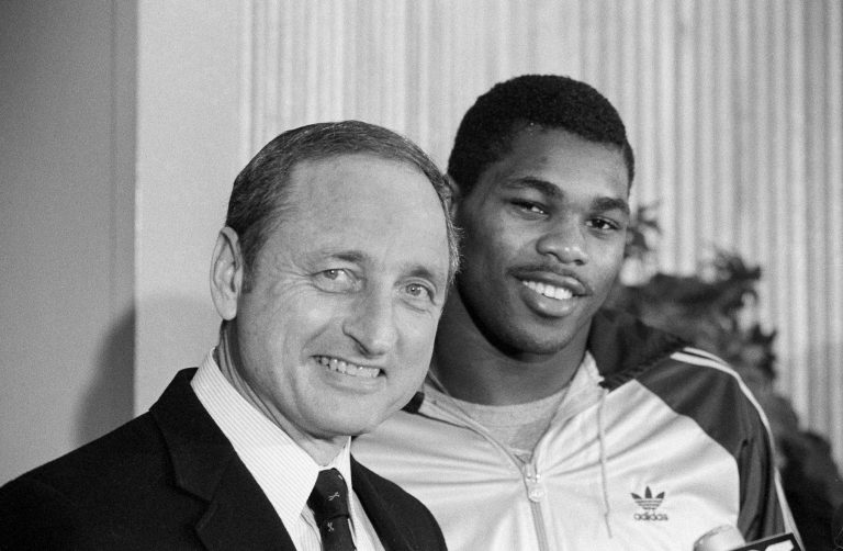 Georgia running back Herschel Walker, right, brings a smile to the face of his coach Vince Dooley as he announces that he would play football next year at Georgia rather than the USFL, Feb. 8, 1983 in Athens, Ga.