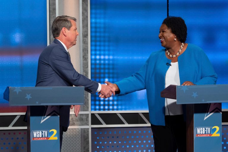 Republican Georgia Gov. Brian Kemp, left, shakes hands with Democratic challenger Stacey Abrams following a televised debate, in Atlanta, Sunday, Oct. 30, 2022. 