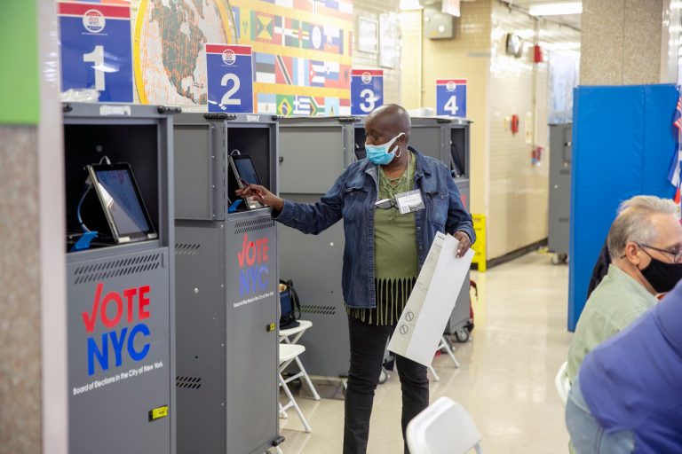 A poll worker prints a ballot from a Board of Elections printing machine at an early voting polling site at Frank McCourt High School on the Upper West Side of Manhattan in New York City.