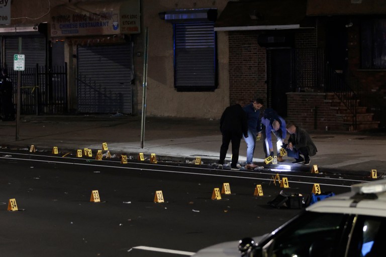 Philadelphia police process part of a crime scene where multiple people were injured in a shooting in Philadelphia late Saturday, Nov. 5.