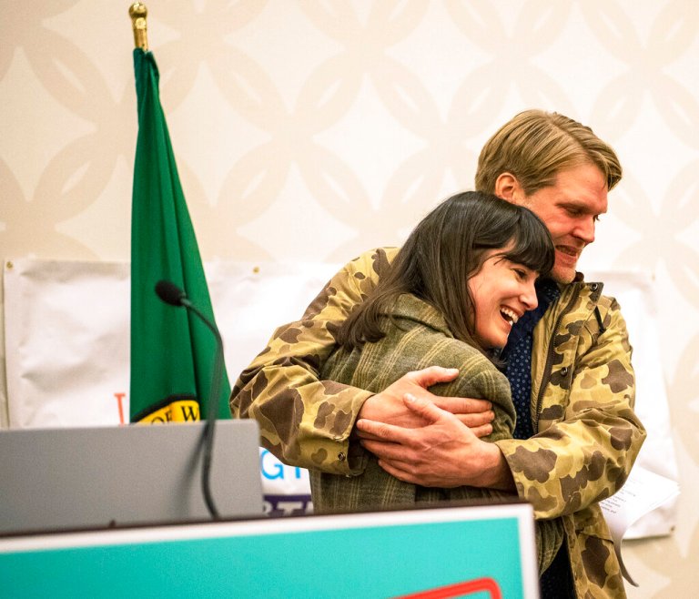 Marie Gluesenkamp Perez, left, hugs her husband Dean Gluesenkamp after delivering a speech to supporters at the Clark County Democrats election night watch party at a hotel in Vancouver, Washington.