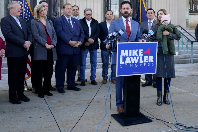 Future Rep. Mike Lawler (R-NY), center, is joined by his wife Doina and daughter Julianna, center right, as he speaks during a news conference on Wednesday, Nov. 9, 2022, in New City, New York.
