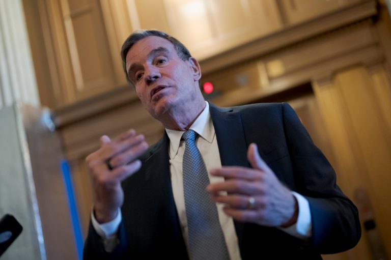 Sen. Mark Warner, D-Va., chair of the Senate Intelligence Committee, pauses to speak with reporters at the Capitol in Washington, Thursday, Nov. 10, 2022.