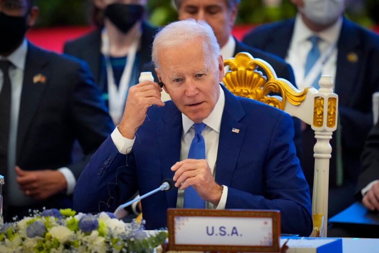 U.S. President Joe Biden adjust his earphone during the ASEAN - US (Association of Southeast Asian Nations) in Phnom Penh, Cambodia, Saturday, Nov. 12, 2022. 