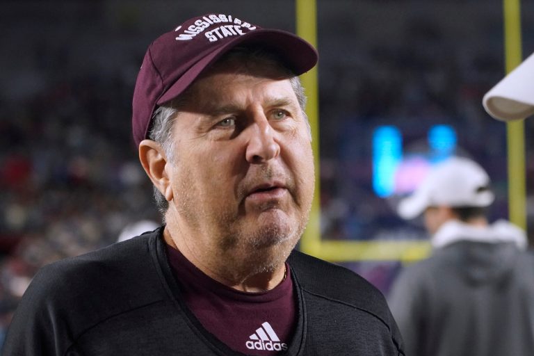 Mississippi State coach Mike Leach talks with Mississippi coach Lane Kiffin before an NCAA college football game in Oxford, Mississippi, Thursday, Nov. 24, 2022.