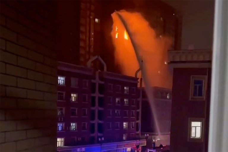 In this image taken from video, firefighters spray water on a fire at a residential building in Urumqi in western China's Xinjiang Uyghur Autonomous Region, Thursday, Nov. 24, 2022. 