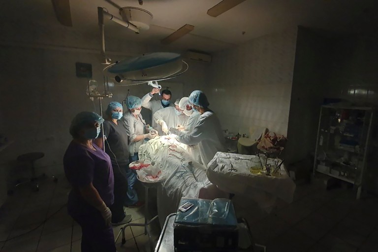 This photo made available by Ukrainian doctor Oleh Duda shows the moment when lights went out as he was performing surgery on a bleeding patient at the hospital in western city of Lviv, Ukraine, on Nov. 15.