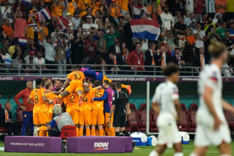 Daley Blind of the Netherlands celebrates with teammates after scoring his side's 2nd goal during the World Cup round of 16 soccer match between the Netherlands and the United States, at the Khalifa International Stadium in Doha, Qatar, Saturday, Dec. 3, 2022.