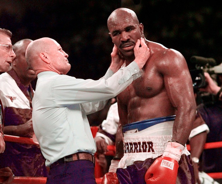 Mills Lane, the Hall of Fame boxing referee who was the third man in the ring when Mike Tyson bit Evander Holyfieldâs ear during the third round of their 1997 WBA heavyweight boxing match in Las Vegas, died Tuesday, Dec. 6, 2022.