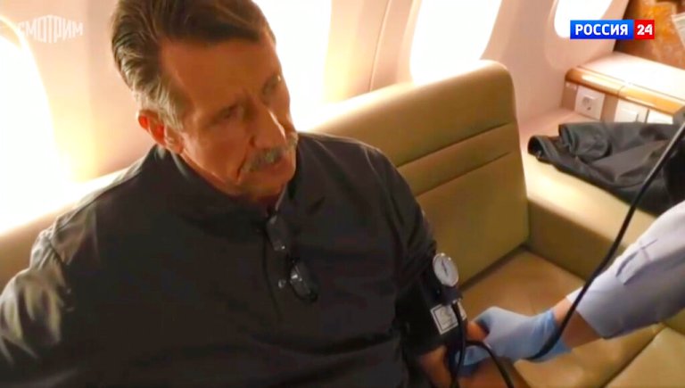 In this image taken from video provided by RU-24 Russian Television on Friday, Dec. 9, 2022, Russian citizen Viktor Bout who was exchanged for U.S. basketball player Brittney Griner, sits in a Russian plane after a swap, in the airport of Abu Dhabi, United Arab Emirates. 