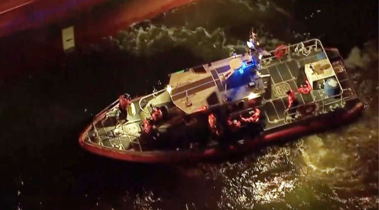 Rescued sailors are seen on board a smaller boat after leaving the Silver Muna tanker ship on Wednesday, Dec. 14, 2022 in New York.