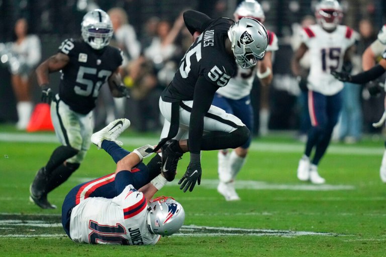 Las Vegas Raiders defensive end Chandler Jones (55) breaks a tackle by New England Patriots quarterback Mac Jones (10) to score a touchdown.