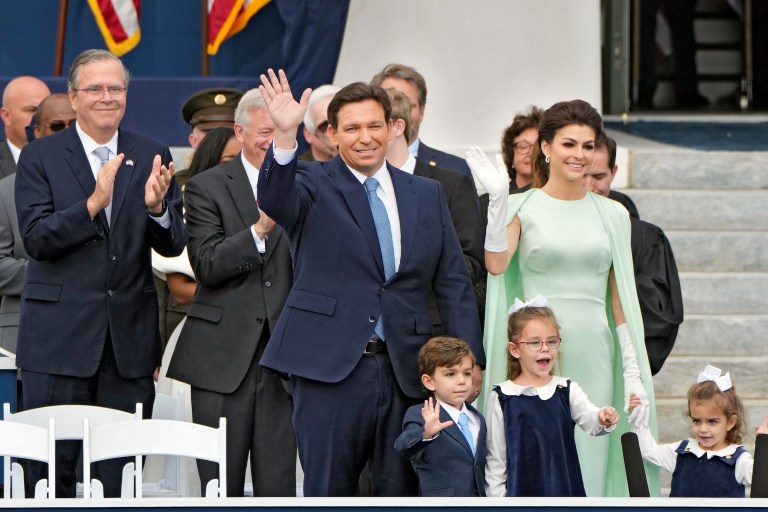 Florida Gov. Ron DeSantis, center, waves as he arrives with his wife Casey, right, and their children Mason, Madison, and Mamie before his inauguration ceremony outside the Old Capitol Tuesday, Jan. 3, 2023, in Tallahassee, Fla. Applauding at left is former Gov. Jeb Bush. 