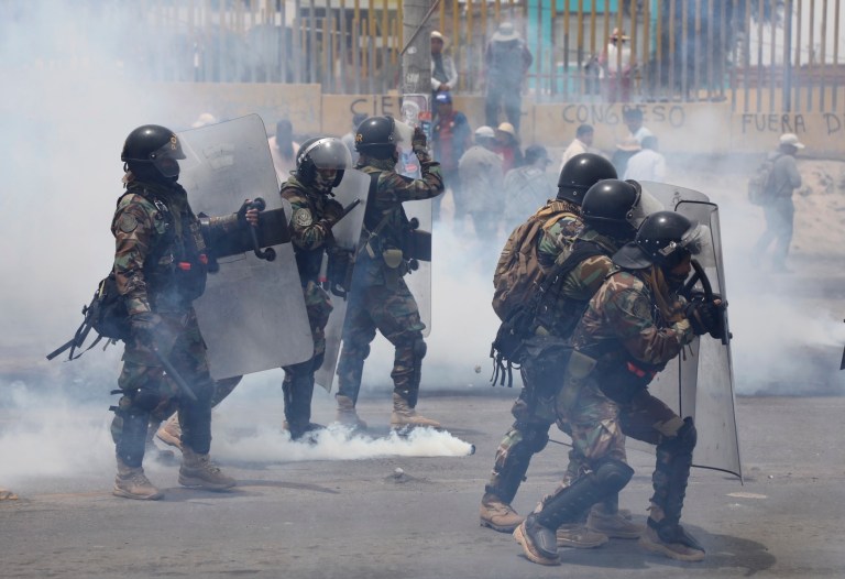 Riot police face off with demonstrators protesting against President Dina Boluarte's government and Congress, in Arequipa, Peru, Wednesday, Jan. 4, 2023.
