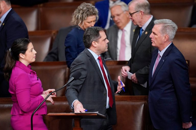 Rep. Elise Stefanik (R-NY), left, and Rep. Mike Garcia (R-CA), center, talk with Rep. Kevin McCarthy (R-CA) in the House chamber as the House meets for the fourth day to elect a speaker and convene the 118th Congress in Washington, Friday, Jan. 6, 2023.