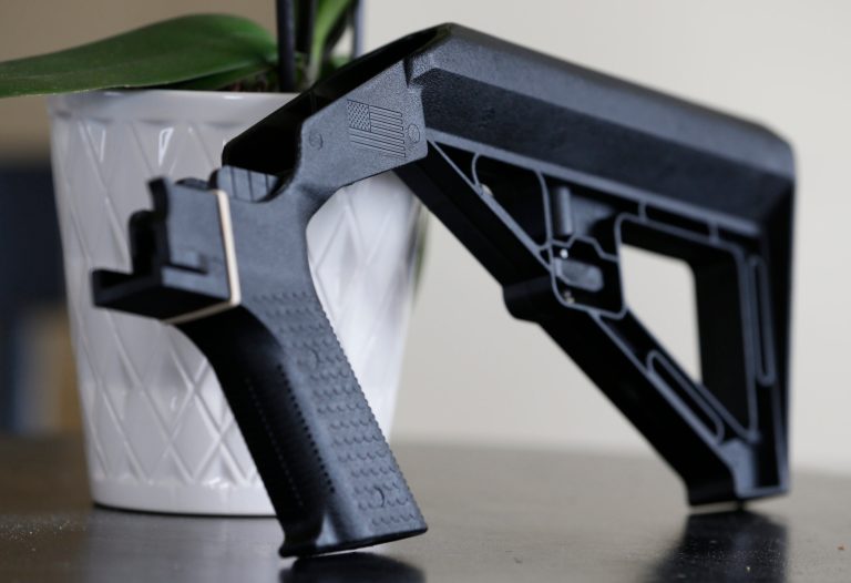FILE - A bump stock is displayed on March 15, 2019, in Harrisonburg, Va.