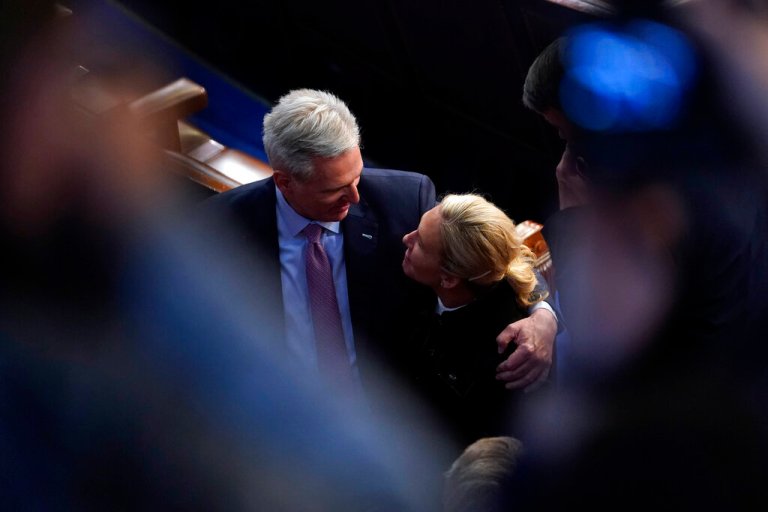Rep. Kevin McCarthy, R-Calif., walks from the House floor with Rep. Marjorie Taylor Greene, R-Ga., after the 13th vote for speaker.