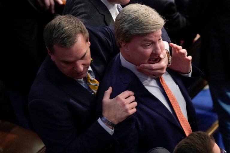 Rep. Richard Hudson, R-N.C., left, pulls Rep. Mike Rogers, R-Ala., back as they talk with Rep. Matt Gaetz, R-Fla., during the 14th round of voting for speaker as the House meets for the fourth day to try and elect a speaker and convene the 118th Congress in Washington, Friday, Jan. 6, 2023.