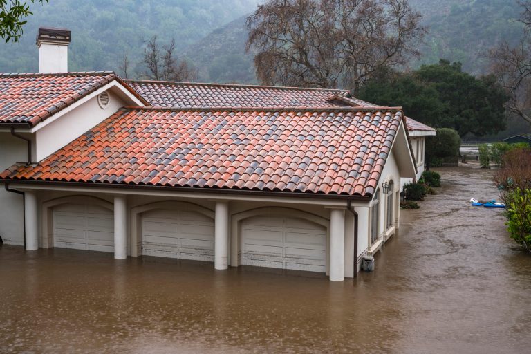 A garage is flooded by the overflowing Carmel River on Paso Hondo Road in Carmel Valley, Calif., on Jan. 9, 2023. 