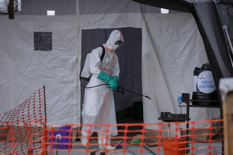 A medical worker disinfects a tent used for suspected Ebola victims inside the Ebola isolation center of Madudu Health Center III, in the village of Madudu, in the Mubende district of Uganda on Nov. 1, 2022. 