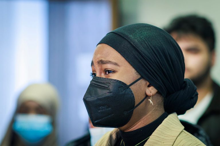 Aram Wedatalla, a Hamline University senior and the president of Muslim Student Association, cries during a news conference. A Hamline University lecturer showed a painting of Muhammad, and Wedatalla was one of the students in the class when the image was displayed.