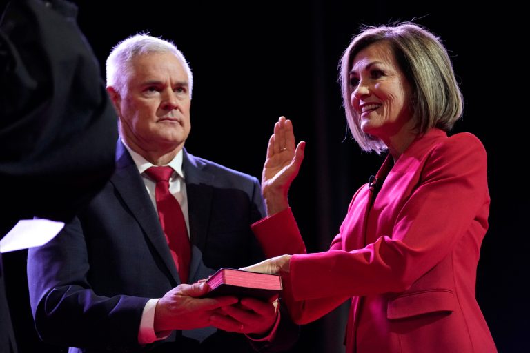 Iowa Gov. Kim Reynolds takes the Oath of Office as her husband Kevin, left, looks on during inauguration ceremonies, Friday, Jan. 13, 2023, in Des Moines, Iowa.