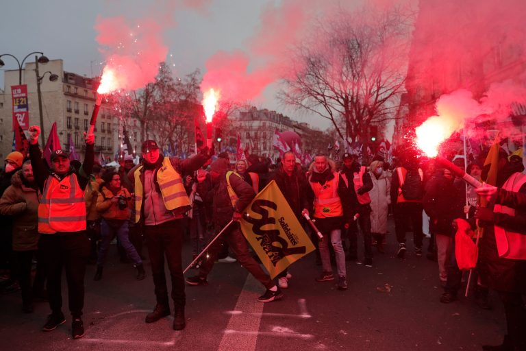 Protestors use flares during a demonstration against pension changes, Thursday, Jan. 19, 2023 in Paris.