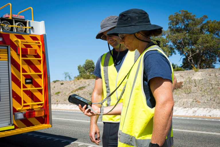 In this photo provided by the Department of Fire and Emergency Services, its members search for a radioactive capsule believed to have fallen off a truck.