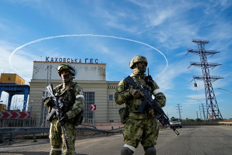 Russian troops guard an entrance of the Kakhovka Hydroelectric Station, a run-of-river power plant on the Dnieper River in Kherson region, south Ukraine, Friday, May 20, 2022. The Kherson region has been under control of the Russian forces since the early days of the Russian military action in Ukraine. This photo was taken during a trip organized by the Russian Ministry of Defense. 