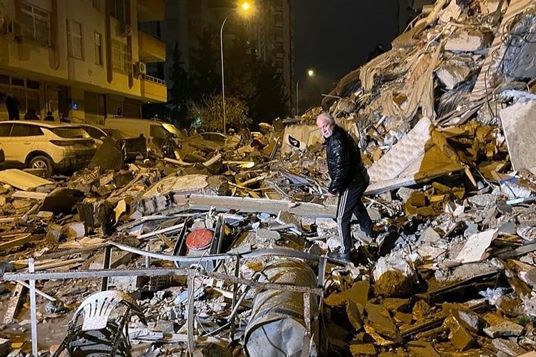 A man searches collapsed buildings in Diyarbakir, southern Turkey, early Monday, Feb. 6, 2023. A powerful earthquake has caused significant damage in southeast Turkey and Syria and many casualties are feared. Damage was reported across several Turkish provinces, and rescue teams were being sent from around the country. 