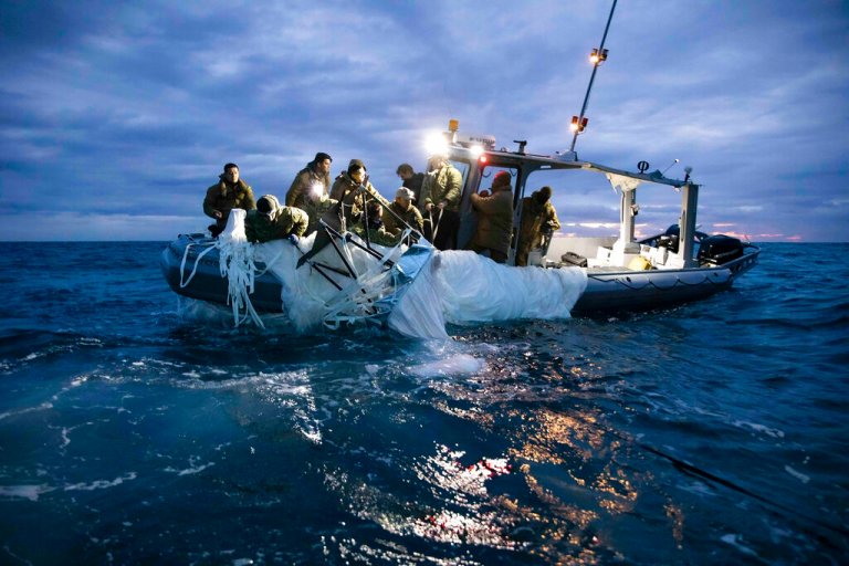 This image provided by the U.S. Navy shows sailors assigned to Explosive Ordnance Disposal Group 2 recovering a high-altitude surveillance balloon off the coast of Myrtle Beach, S.C., Feb. 5, 2023.