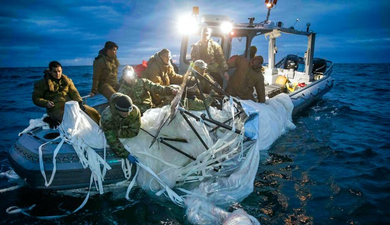 This image provided by the U.S. Navy shows sailors assigned to Explosive Ordnance Disposal Group 2 recovering a high-altitude surveillance balloon off the coast of Myrtle Beach, S.C., Feb. 5, 2023.