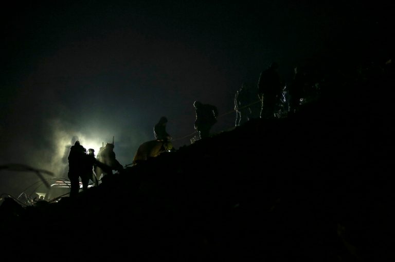 Rescue teams search for people at a destroyed building, in Adiyaman, Wednesday, Feb. 8, 2023.