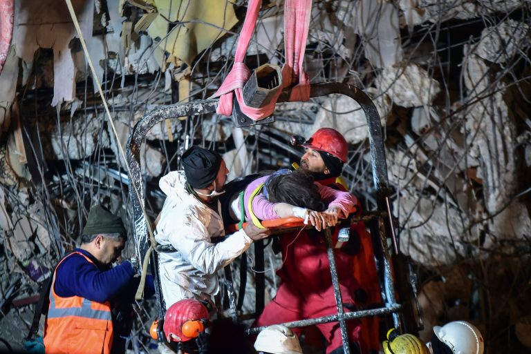 Rescuers pull out a woman from a collapsed building 87 hours after the earthquake in Kahramanmaras, southern Turkey, Thursday, Feb. 9, 2023. 