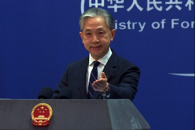 Chinese Foreign Ministry spokesman Wang Wenbin gestures as he speaks during a media briefing at the Ministry of Foreign Affairs office in Beijing, Monday, Feb. 13, 2023. 