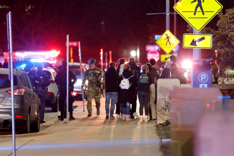 Students gather on the campus of Michigan State University after a shelter in place order was lifted early Tuesday, Feb. 14, 2023, in East Lansing, Mich. A gunman opened fire Monday night at Michigan State University, killing three people and wounding five more before fatally shooting himself after an hourslong manhunt that forced frightened students to hide in the dark.