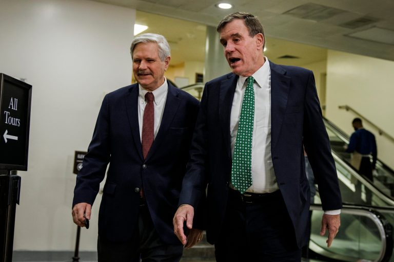 (L-R) U.S. Senators John Hoeven (R-ND) and Mark Warner (D-VA) head to a classified briefing for Senators on the recent incursion of a Chinese spy balloon into U.S. air space on Capitol Hill in Washington, D.C., on Feb. 14, 2023. 