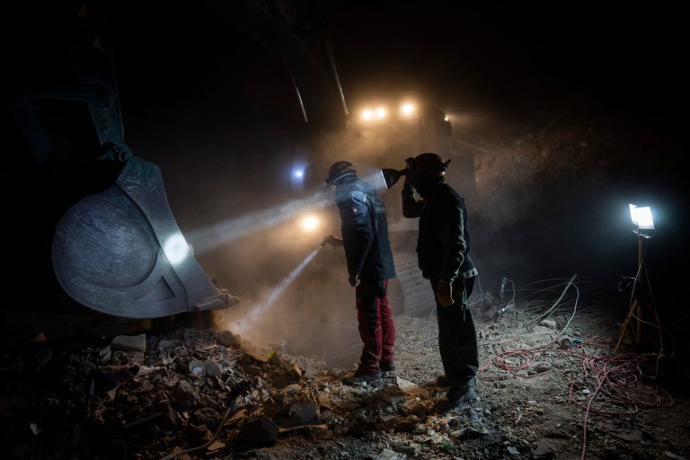 Members of NGOs Deathcare Embalming Team and Turkish Kurt-Ar inspect the bucket of an excavator as they search for bodies after the earthquake in Kahramanmaras, Turkey, Friday, Feb. 17, 2023.