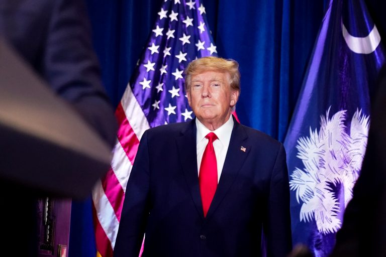 Former President Donald Trump listens as he is introduced to speak at the South Carolina Statehouse, Jan. 28, 2023, in Columbia, South Carolina. 