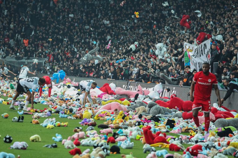 Fans throw toys onto the pitch during the Turkish Super League soccer match between Besiktas and Antalyaspor at the Vodafone stadium in Istanbul, Turkey.