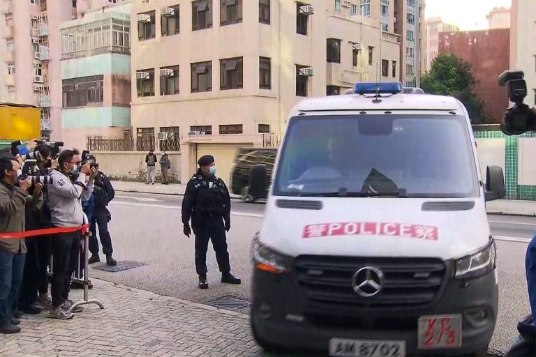 In this image taken from video footage run by TVB Hong Kong, journalists film a police van believed to be carrying relatives of murdered model Abby Choi.