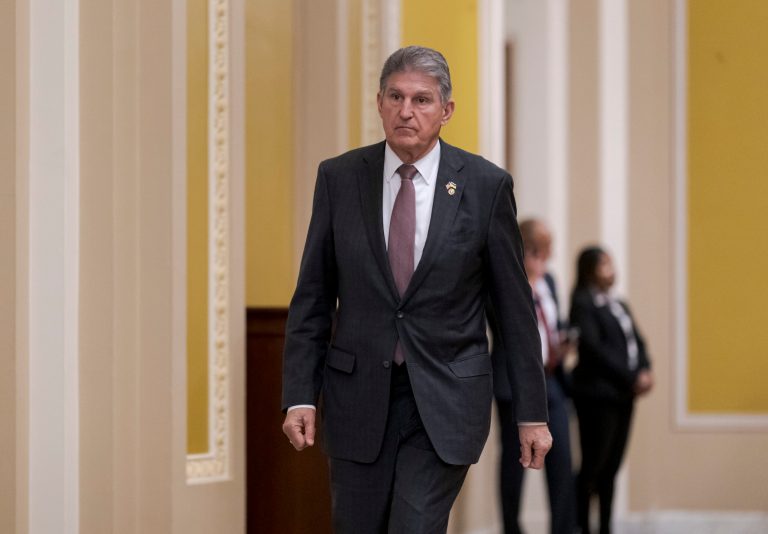 Sen. Joe Manchin, D-W.Va., heads to the chamber for a vote during a lunch with Senate Democrats and President Joe Biden, at the Capitol in Washington, Thursday, March 2, 2023.