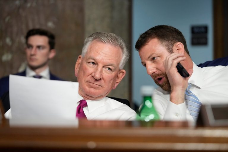 Sen. Tommy Tuberville, R-Ala., left, and Sen. Markwayne Mullin, R-Okla., talk during a Senate Armed Services Committee hearing on Capitol Hill, Tuesday, March 7, 2023, in Washington.