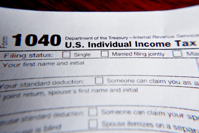 FILE - This Feb. 13, 2019 file photo shows part of a 1040 federal tax form printed from the Internal Revenue Service website, in Zelienople, Pennsylvania. (AP Photo/Keith Srakocic, File)