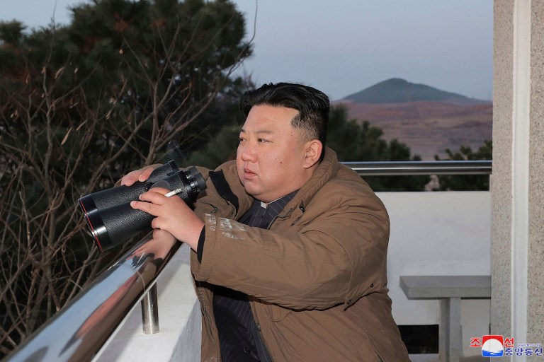 In this photo provided by the North Korean government, North Korean leader Kim Jong Un watches what it says is an intercontinental ballistic missile the country test-launched at the Sunan international airport in Pyongyang, North Korea, Thursday, March 16, 2023. 