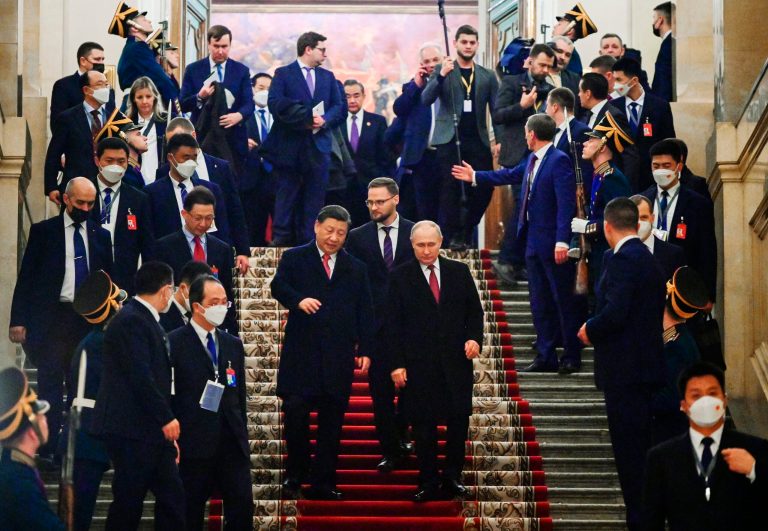 Chinese President Xi Jinping, center left, and Russian President Vladimir Putin, center right, step down after their dinner at The Palace of the Facets in the Moscow Kremlin, Russia, Tuesday, March 21, 2023. 