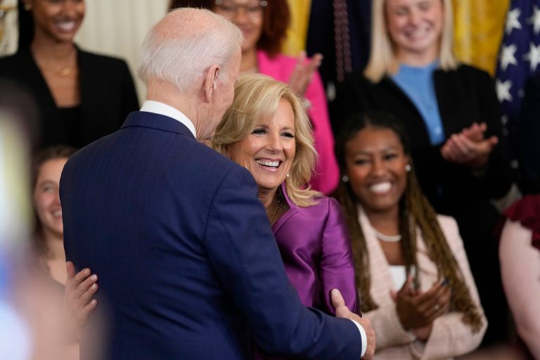 President Joe Biden hugs first lady Jill Biden during an event in the East Room of the White House in Washington, D.C., Wednesday, March 22, 2023, that celebrates women's history month.